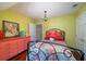 Bedroom with coral dresser and double bed with floral quilt at 6949 Maybank Hwy, Wadmalaw Island, SC 29487