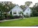 White home with a sunroom addition and landscaping at 6949 Maybank Hwy, Wadmalaw Island, SC 29487