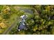 Aerial view of home on wooded lot with pond at 6949 Maybank Hwy, Wadmalaw Island, SC 29487