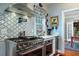 Modern kitchen with stainless steel appliances and a unique patterned backsplash at 6949 Maybank Hwy, Wadmalaw Island, SC 29487