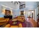 Open living room with hardwood floors, high ceilings, and a view of the foyer at 6949 Maybank Hwy, Wadmalaw Island, SC 29487