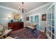 Sitting room with French doors, hardwood floors, and comfortable seating at 6949 Maybank Hwy, Wadmalaw Island, SC 29487
