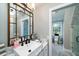 Bathroom with marble vanity, walk-in shower, and toilet at 6949 Maybank Hwy, Wadmalaw Island, SC 29487