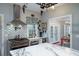 A bright kitchen showcasing a marble island, stainless steel range, and custom backsplash at 6949 Maybank Hwy, Wadmalaw Island, SC 29487