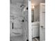 Walk-in shower with marble walls and glass enclosure at 6949 Maybank Hwy, Wadmalaw Island, SC 29487