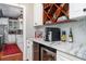 Well-equipped kitchen boasting a wine cooler, espresso machine, and marble countertops at 6949 Maybank Hwy, Wadmalaw Island, SC 29487