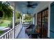 Side porch with seating area and view of backyard at 6949 Maybank Hwy, Wadmalaw Island, SC 29487