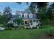 Two-story home with wrap-around porch and fountain at 6949 Maybank Hwy, Wadmalaw Island, SC 29487