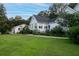 White two-story home with attached garage and landscaping at 6949 Maybank Hwy, Wadmalaw Island, SC 29487