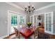 Bright dining room with hardwood floors, chandelier, and French doors at 6949 Maybank Hwy, Wadmalaw Island, SC 29487
