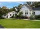 White home with sunroom and attached garage at 6949 Maybank Hwy, Wadmalaw Island, SC 29487