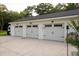 Three-car garage with light gray doors and black accents at 6949 Maybank Hwy, Wadmalaw Island, SC 29487
