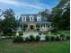 Beautiful two-story home with wrap-around porch and fountain at 6949 Maybank Hwy, Wadmalaw Island, SC 29487
