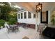 Outdoor patio with seating area, grill, and access to the house at 6949 Maybank Hwy, Wadmalaw Island, SC 29487