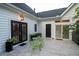 Small patio with bistro table and chairs, adjacent to the house at 6949 Maybank Hwy, Wadmalaw Island, SC 29487