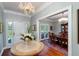 Elegant entryway with a round table, chandelier, and views into the dining room at 6949 Maybank Hwy, Wadmalaw Island, SC 29487