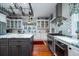 Modern kitchen with white cabinets, marble countertops, and stainless steel appliances at 6949 Maybank Hwy, Wadmalaw Island, SC 29487