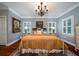 Spacious bedroom with a large bed, hardwood floors, and plantation shutters at 6949 Maybank Hwy, Wadmalaw Island, SC 29487