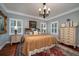 Bright bedroom with king-size bed, hardwood floors, and decorative pillows at 6949 Maybank Hwy, Wadmalaw Island, SC 29487