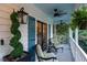 Relaxing side porch with seating and lush greenery at 6949 Maybank Hwy, Wadmalaw Island, SC 29487
