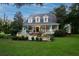 Two-story home with wrap-around porch and fountain at 6949 Maybank Hwy, Wadmalaw Island, SC 29487