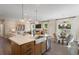 Open concept kitchen with large island, stainless steel sink, and hardwood floors at 120 Palfrey Dr, Ridgeville, SC 29472