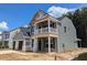 New construction home with gray siding, a balcony, and a two-car garage at 120 Palfrey Dr, Ridgeville, SC 29472