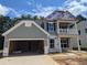 New construction home with gray siding, a balcony, and a two-car garage at 120 Palfrey Dr, Ridgeville, SC 29472