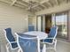 Private deck with outdoor dining set, ceiling fan, and sliding glass door access at 1309 Pelican Watch Villas, Seabrook Island, SC 29455