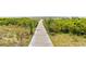 Wooden boardwalk path meandering through coastal vegetation toward the beach at 1309 Pelican Watch Villas, Seabrook Island, SC 29455