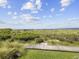Elevated boardwalk offering scenic views of the marsh and ocean at 1309 Pelican Watch Villas, Seabrook Island, SC 29455
