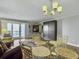 Living room with hardwood floors, glass dining table, and access to a balcony with ocean views at 1309 Pelican Watch Villas, Seabrook Island, SC 29455