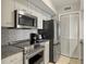 Modern kitchen with stainless steel appliances and granite countertops at 1309 Pelican Watch Villas, Seabrook Island, SC 29455