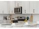 Stainless steel appliances and gold faucet above white cabinets at 229 Abercom Place Dr, Moncks Corner, SC 29461