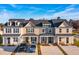 Aerial view showcasing four townhomes with unique color schemes and ample parking at 229 Abercom Place Dr, Moncks Corner, SC 29461