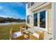 Cozy patio with wicker furniture and glass-top table at 229 Abercom Place Dr, Moncks Corner, SC 29461