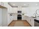 Modern kitchen with white cabinets, stainless steel appliances, and wood flooring at 229 Abercom Place Dr, Moncks Corner, SC 29461