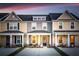 Three-unit townhome building with light beige and gray siding, dark gray roofs, and covered porches at 229 Abercom Place Dr, Moncks Corner, SC 29461