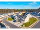 An aerial view of a new townhome community nestled amongst trees and open green spaces at 229 Abercom Place Dr, Moncks Corner, SC 29461