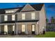 Attractive two-story townhome with front porch and well-lit exterior at dusk at 229 Abercom Place Dr, Moncks Corner, SC 29461