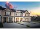 Three-unit townhome building with light beige and gray siding, dark gray roofs, and covered porches at 229 Abercom Place Dr, Moncks Corner, SC 29461
