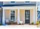 Inviting front porch with two chairs and a dark brown door at 229 Abercom Place Dr, Moncks Corner, SC 29461