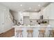 Kitchen island with marble countertop and four light wood stools at 229 Abercom Place Dr, Moncks Corner, SC 29461