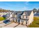 Aerial view of three townhomes with gray and beige siding and welcoming front porches at 229 Abercom Place Dr, Moncks Corner, SC 29461