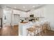 Open concept kitchen with marble island and four wooden barstools at 229 Abercom Place Dr, Moncks Corner, SC 29461