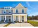 Two-story tan and gray townhome with a front porch and two-car driveway at 229 Abercom Place Dr, Moncks Corner, SC 29461