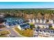 Aerial view of a townhome community near a pond and lush greenery at 229 Abercom Place Dr, Moncks Corner, SC 29461