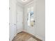Light and spacious entryway with hardwood floors, white doors, and a view of the front porch at 229 Abercom Place Dr, Moncks Corner, SC 29461