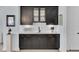 Elegant wet bar with dark cabinetry, quartz countertops, and glass-front cabinets at 377 Tupelo Lake Dr, Summerville, SC 29486