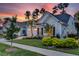 Light blue house with two-car garage and landscaping at sunset at 377 Tupelo Lake Dr, Summerville, SC 29486